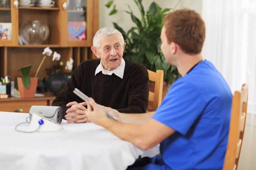 Male Nurse Visiting Senior Patient at Home