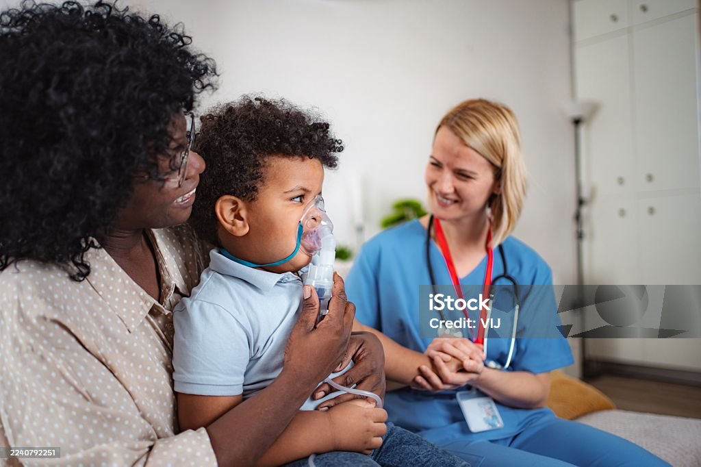 Pediatric nurse checking child's health during home visit